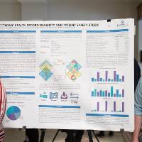 Health informatics and bioinformatics graduate students, Sierra Strutz (left) and Jacob Jackson (right), standing in front of their poster.